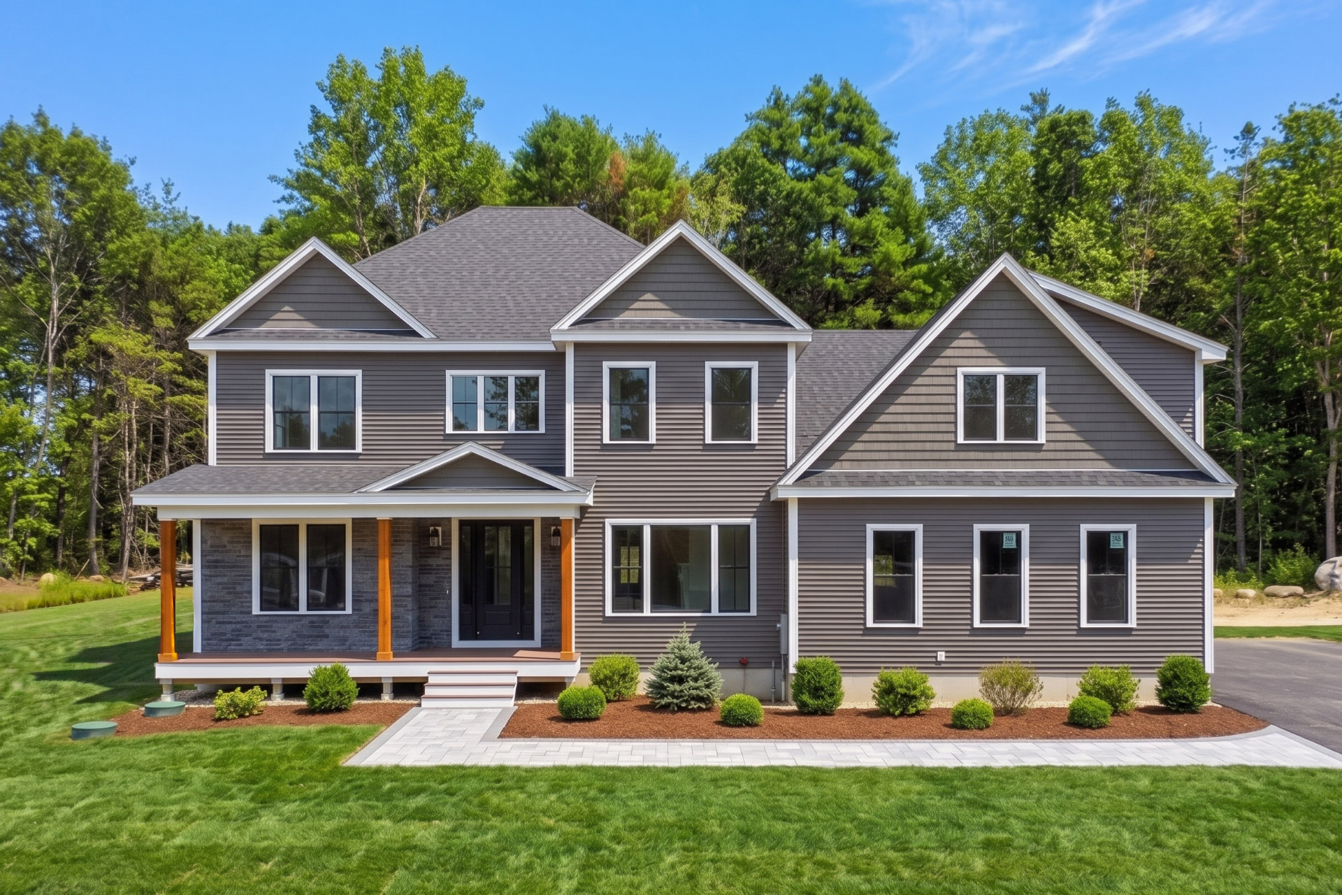 Custom home under construction wrapped in weather barrier